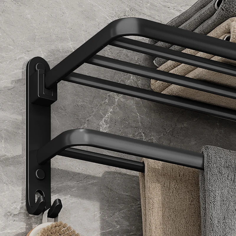 Close-up of the towel rack's wall bracket showing the hinge block for the folding shelf, the double bar and the double hook