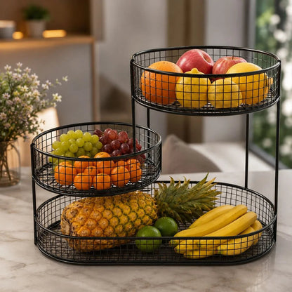 Black three tier wire fruit stand filled with fruit on a marble kitchen counter