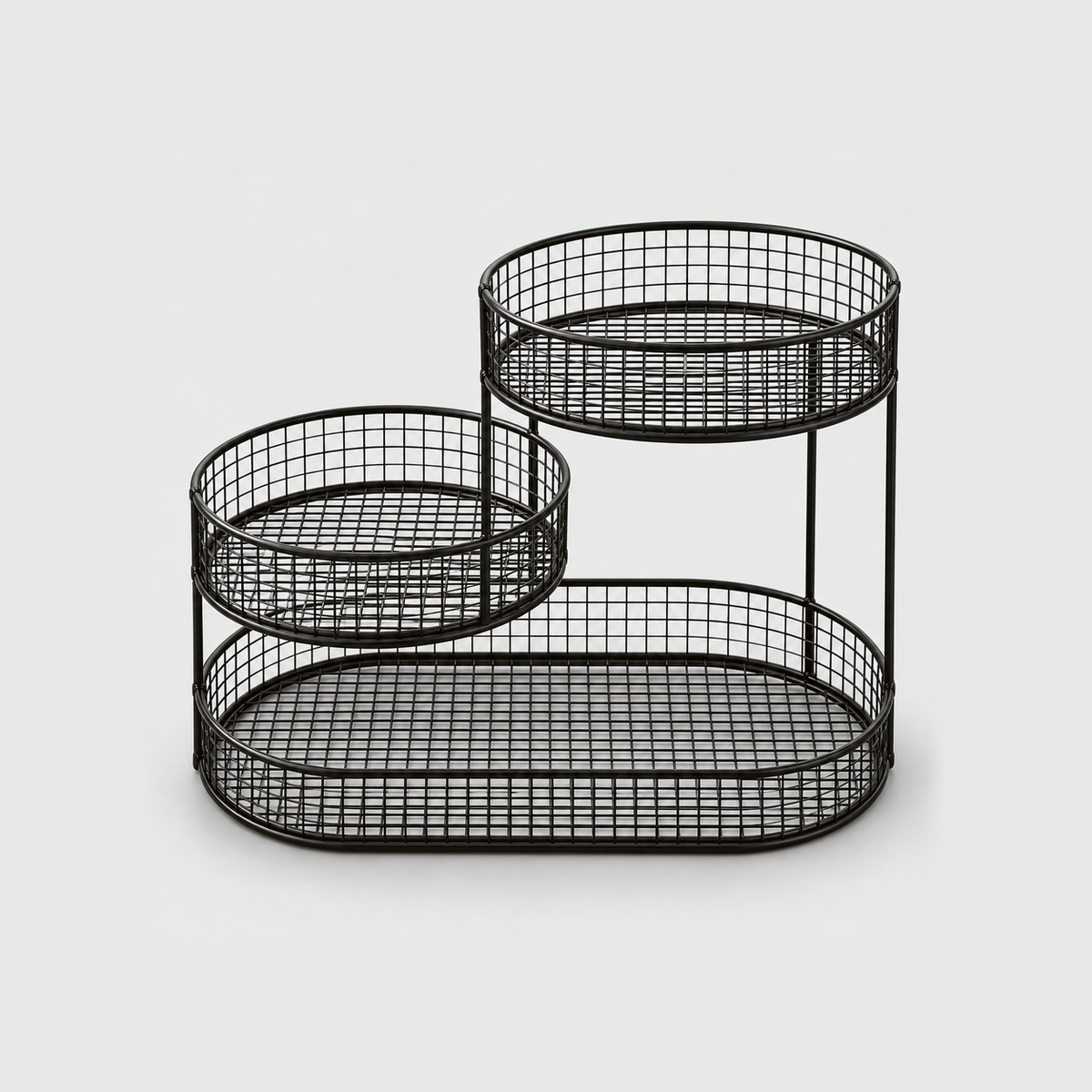 The black three tier fruit stand empty, showing the wire grid floors and the slim upright rods, on a plain light gray background