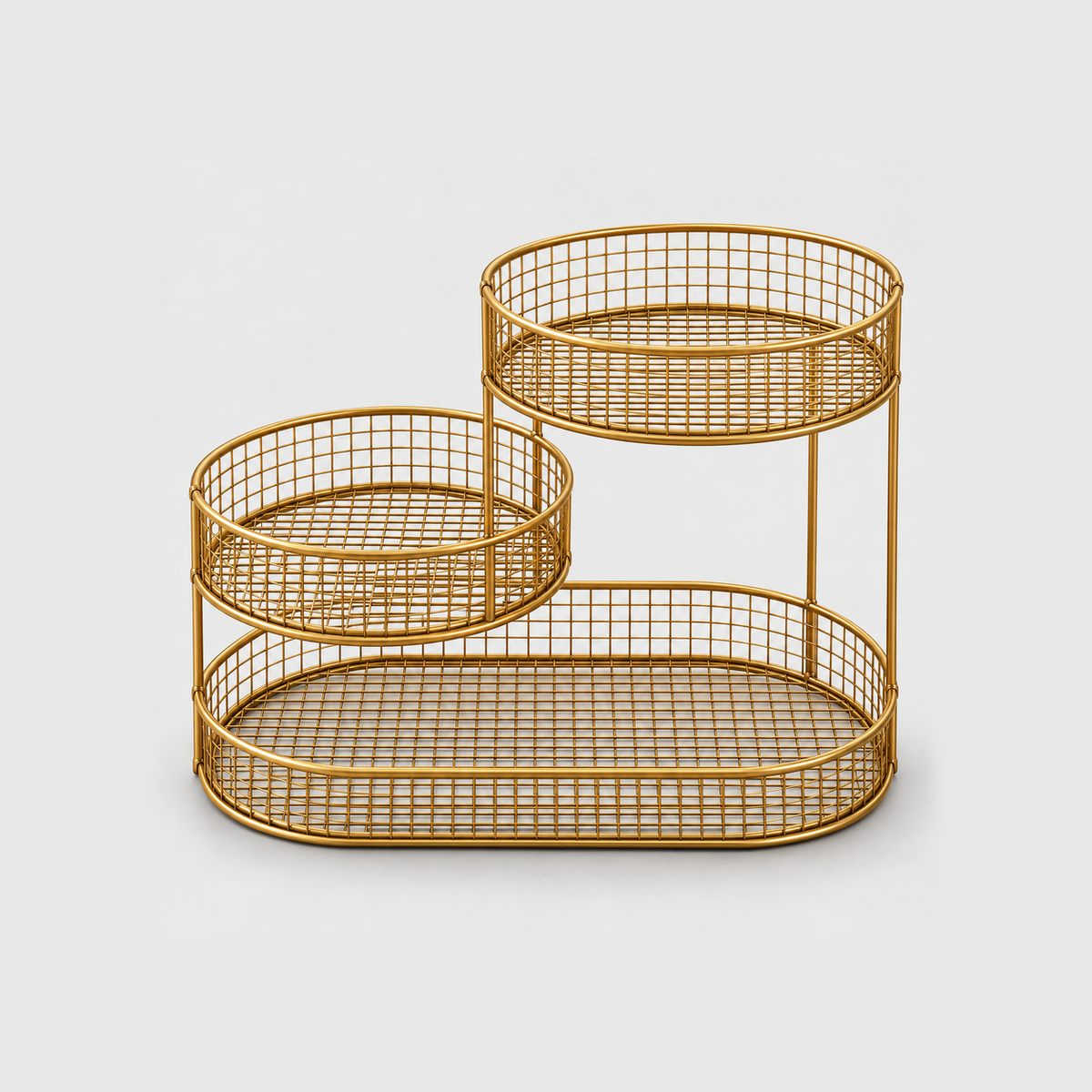 The gold three tier fruit stand empty, showing the wire grid floors and the slim upright rods, on a plain light gray background
