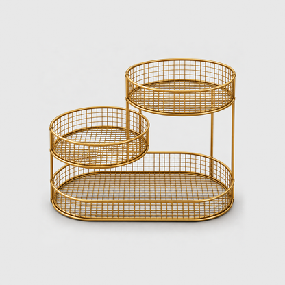 The gold three tier fruit stand empty, showing the wire grid floors and the slim upright rods, on a plain light gray background