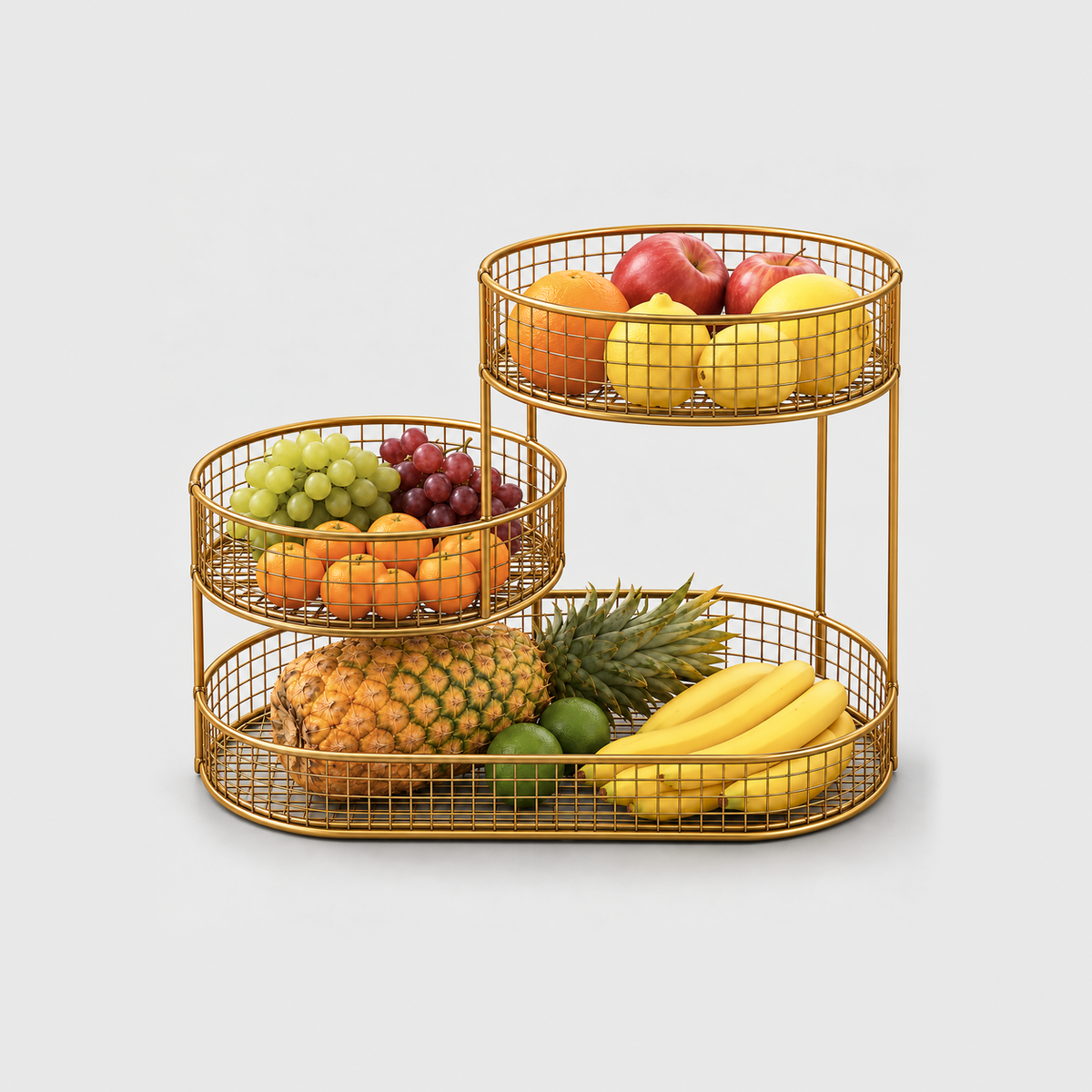 Gold 3 tier fruit basket stand filled with pineapple, bananas, grapes, oranges, lemons and apples, on a plain light gray background