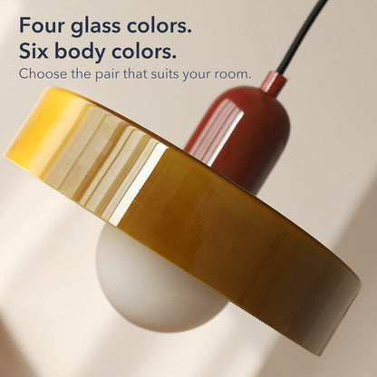 Close-up of an olive glass ring shade on a burgundy body with the words Four glass colors. Six body colors.
