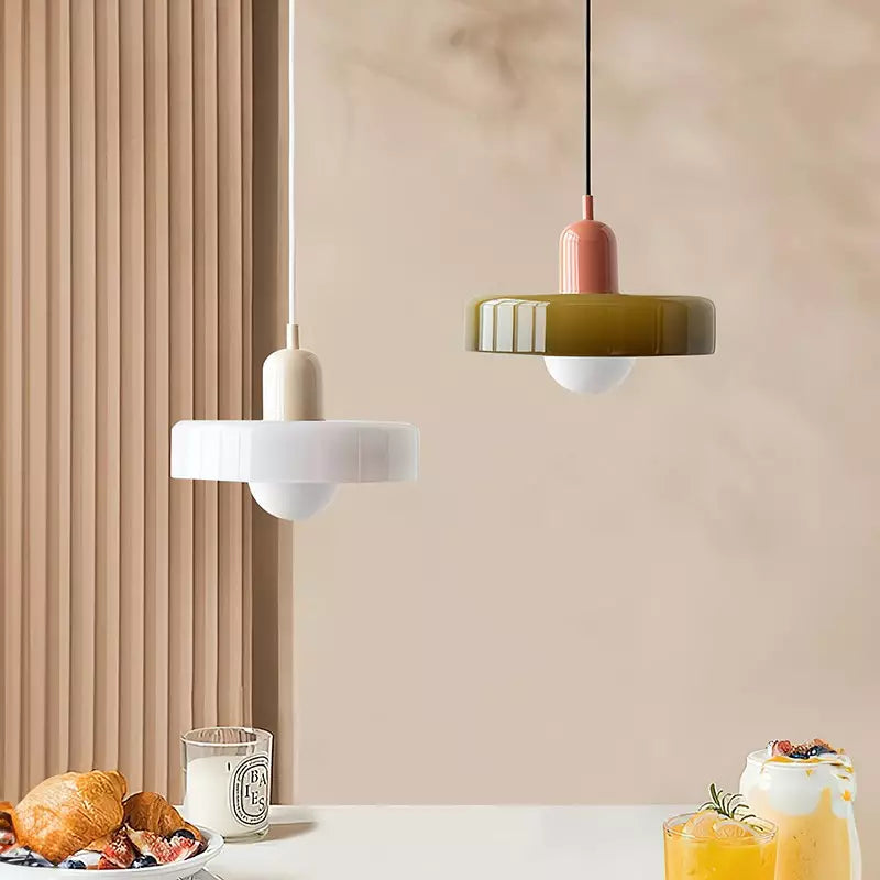 A white shade on a beige body and an olive shade on a pink body over a table set with food and drinks