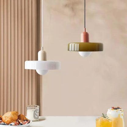 A white shade on a beige body and an olive shade on a pink body over a table set with food and drinks