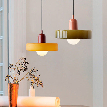 An amber shade on a burgundy body and an olive shade on a pink body over a table with dried flowers