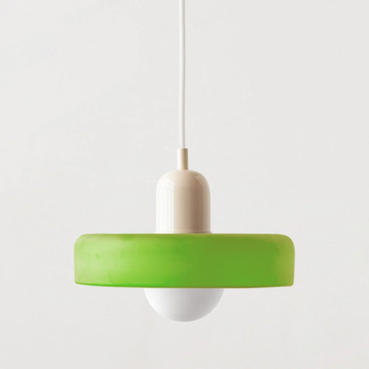 Bauhaus pendant light with a matte green glass ring shade, a beige body and a white cord