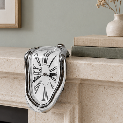 A mirror silver melting clock draped over the edge of a pale stone mantel in a living room