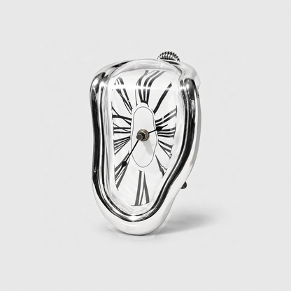 A mirror silver melting clock with stretched Roman numerals standing on a light gray background