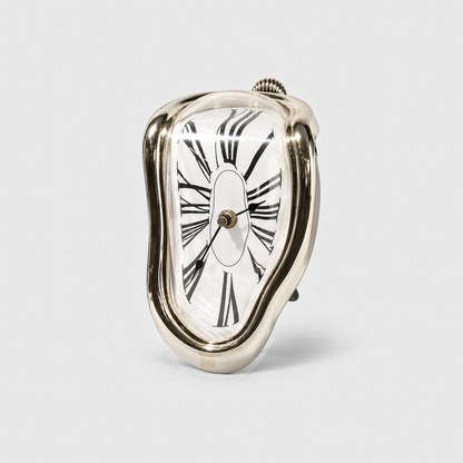 A mirror gold melting clock with stretched Roman numerals standing on a light gray background