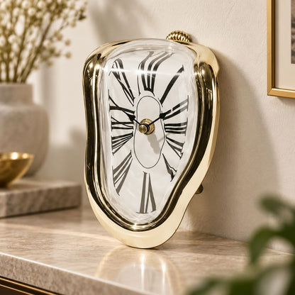 A mirror gold melting clock standing on a marble shelf in warm light