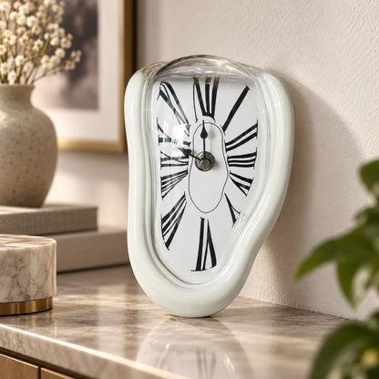 A glossy white melting clock standing on a marble shelf beside a stone vase