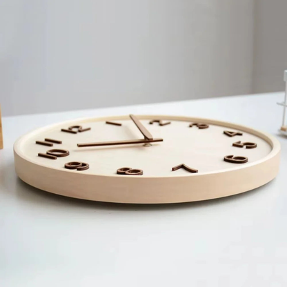 Natural wood wall clock lying flat, seen from the side to show the deep wooden case and the face set down inside the rim