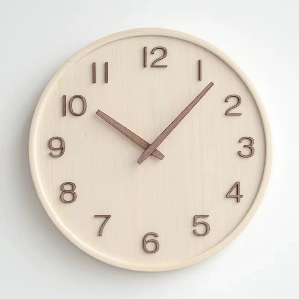 Natural wood wall clock seen straight on, with raised walnut numbers 1 to 12 and two slim walnut hands