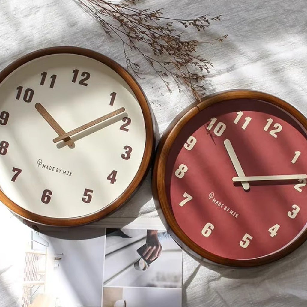The White and Red clocks side by side on a linen cloth in soft sunlight with dried flowers