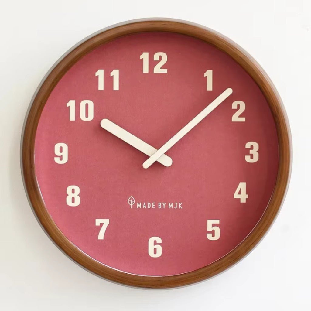 Front view of the Red clock showing the wood frame, the cream numbers and the cream hands