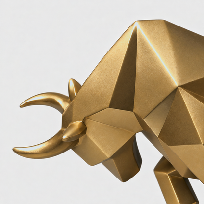 Close view of the gold bull sculpture's faceted head and smooth forward-curving horns