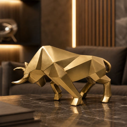 A gold geometric bull sculpture on a marble table with a softly lit lounge behind it