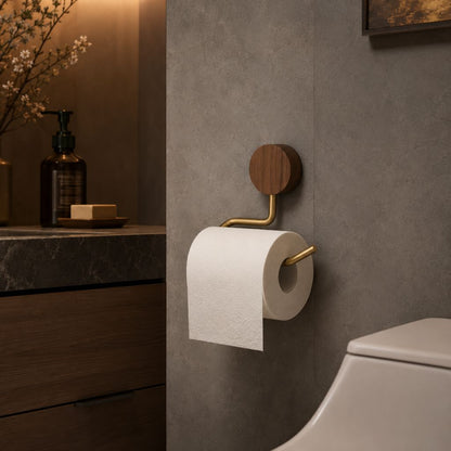 Walnut and gold toilet paper holder with a roll, beside a dark wood vanity and a toilet