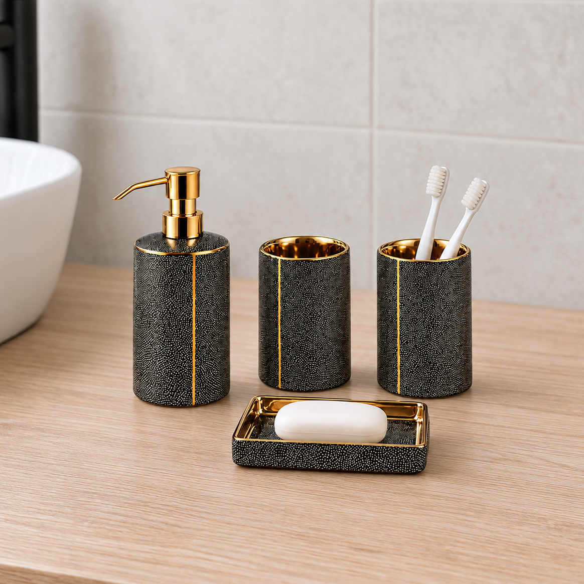 Black ceramic soap dispenser, two tumblers and soap dish standing on a pale oak bathroom vanity in daylight, toothbrushes in one tumbler