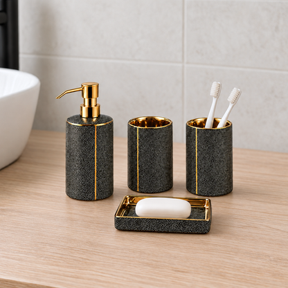 Black ceramic soap dispenser, two tumblers and soap dish standing on a pale oak bathroom vanity in daylight, toothbrushes in one tumbler