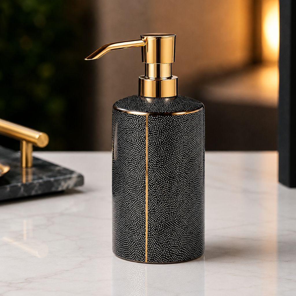 Black ceramic soap dispenser with a gold-tone pump and a gold-coated seam line