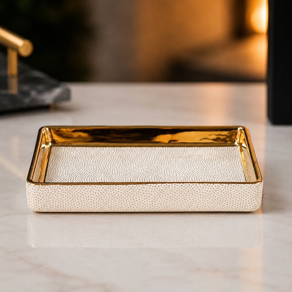 White ceramic soap dish with gold-coated inner walls and a dotted floor
