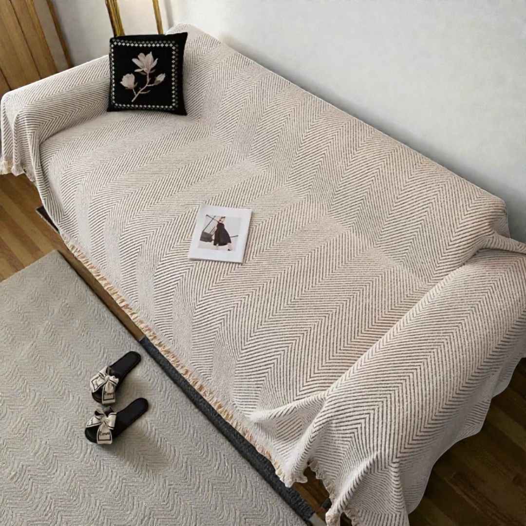 Ivory herringbone cover spread over a whole sofa seen from above, the pattern running across the seat and back and down the side