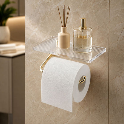 Gold toilet paper holder seen from the right, showing the open end of the arm turning up inside the roll, on a marble wall