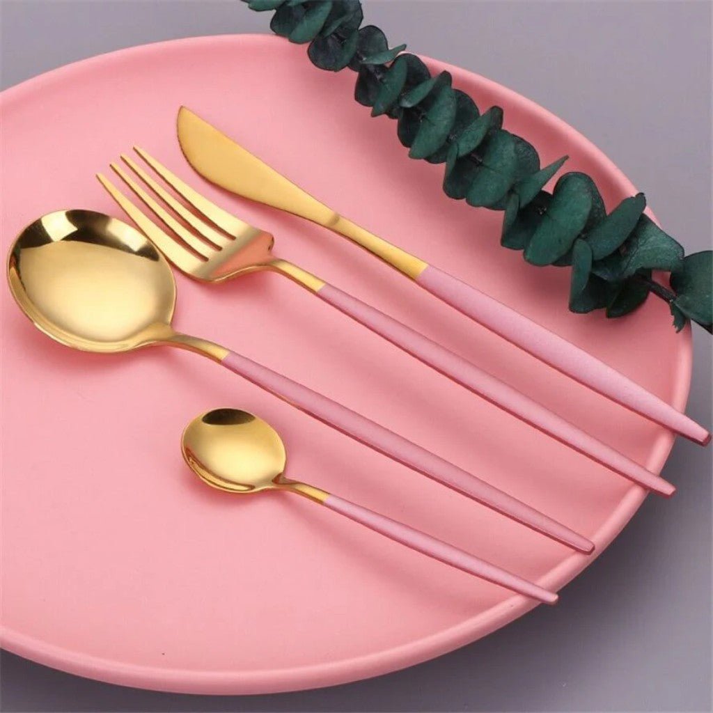 Pink and gold flatware on a pink plate