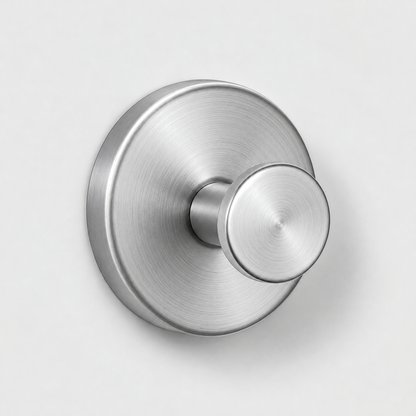 Brushed silver suction cup wall hook on a light gray wall