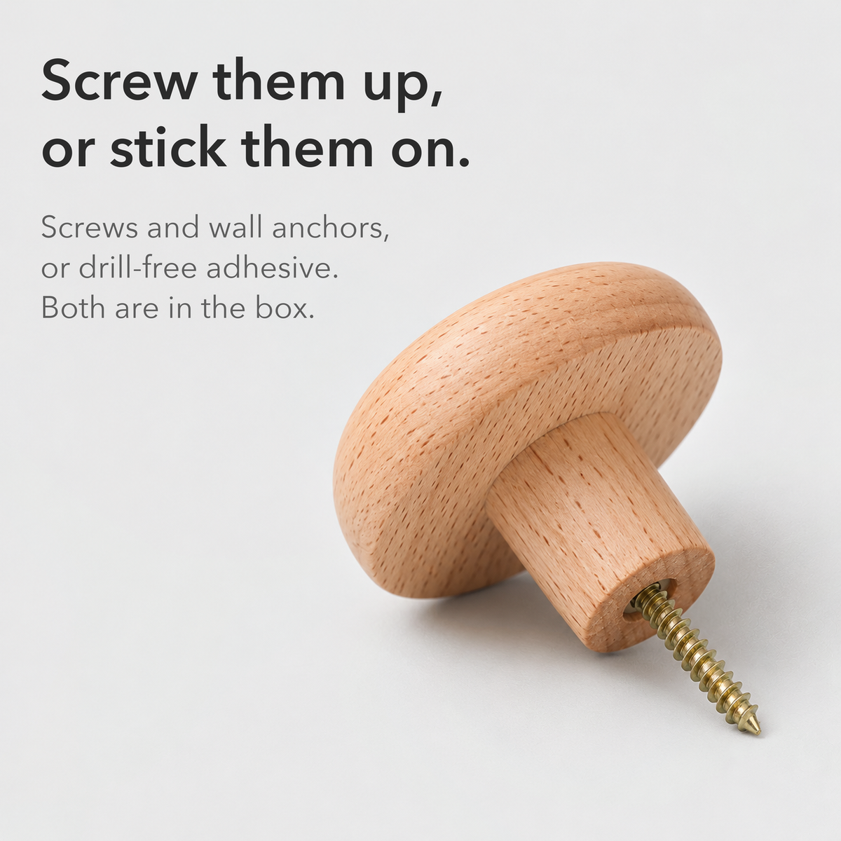 Beech pebble wall hook with its mounting screw, text reading screw them up or stick them on