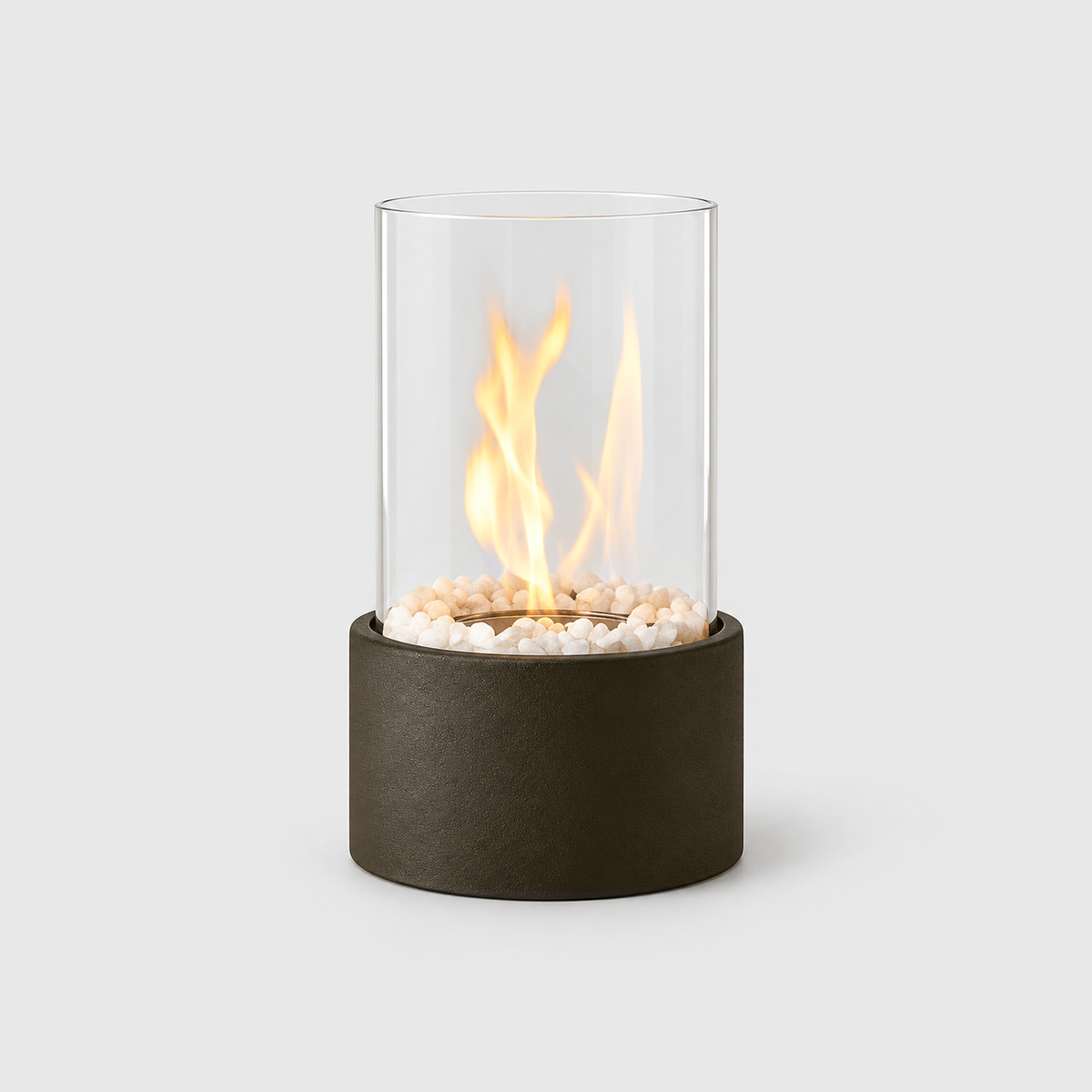 Black glass cylinder tabletop fire pit with a lit flame inside the clear glass and a matte textured base, on a light gray background