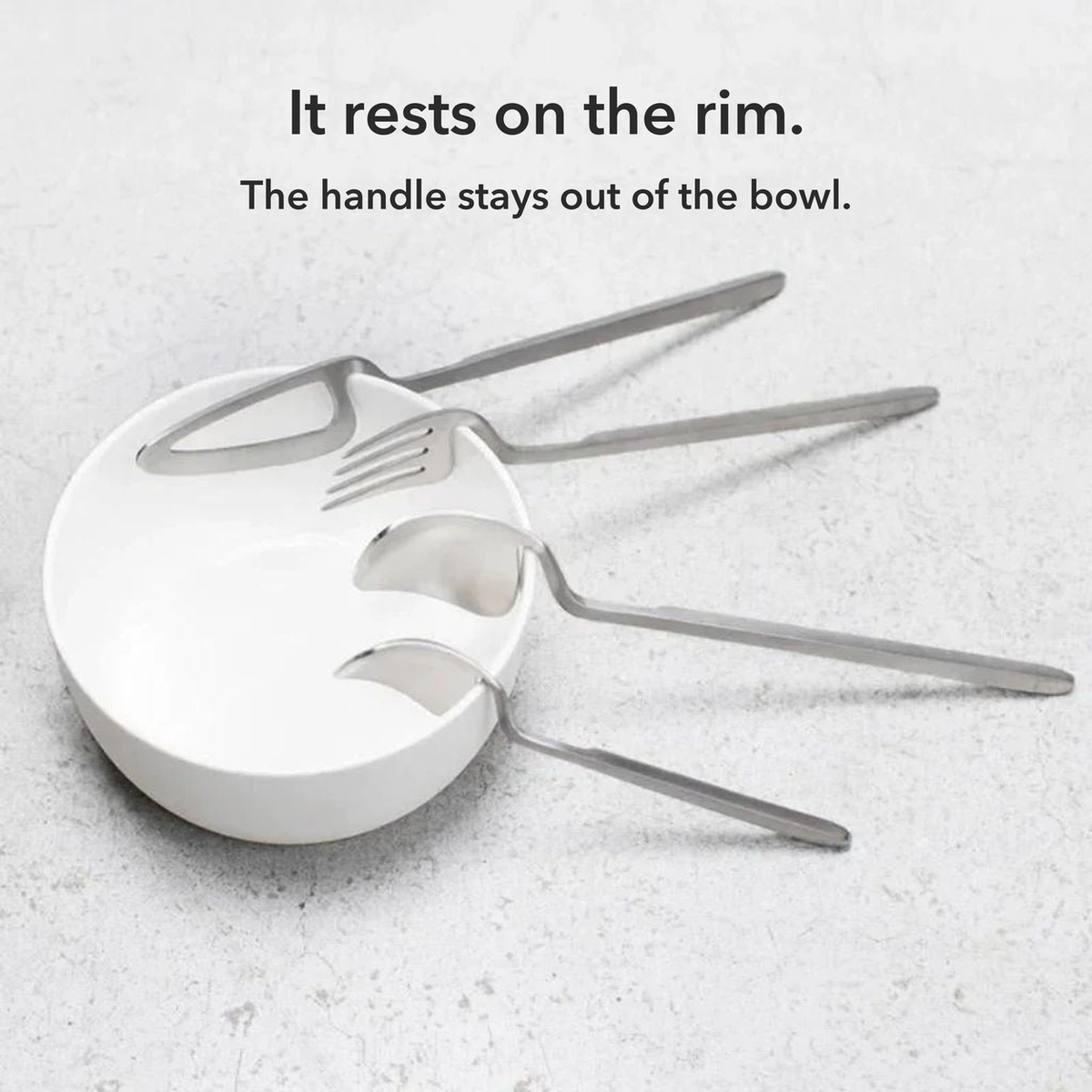 Silver knife, fork, spoon and teaspoon resting on the rim of a white bowl, with the words It rests on the rim