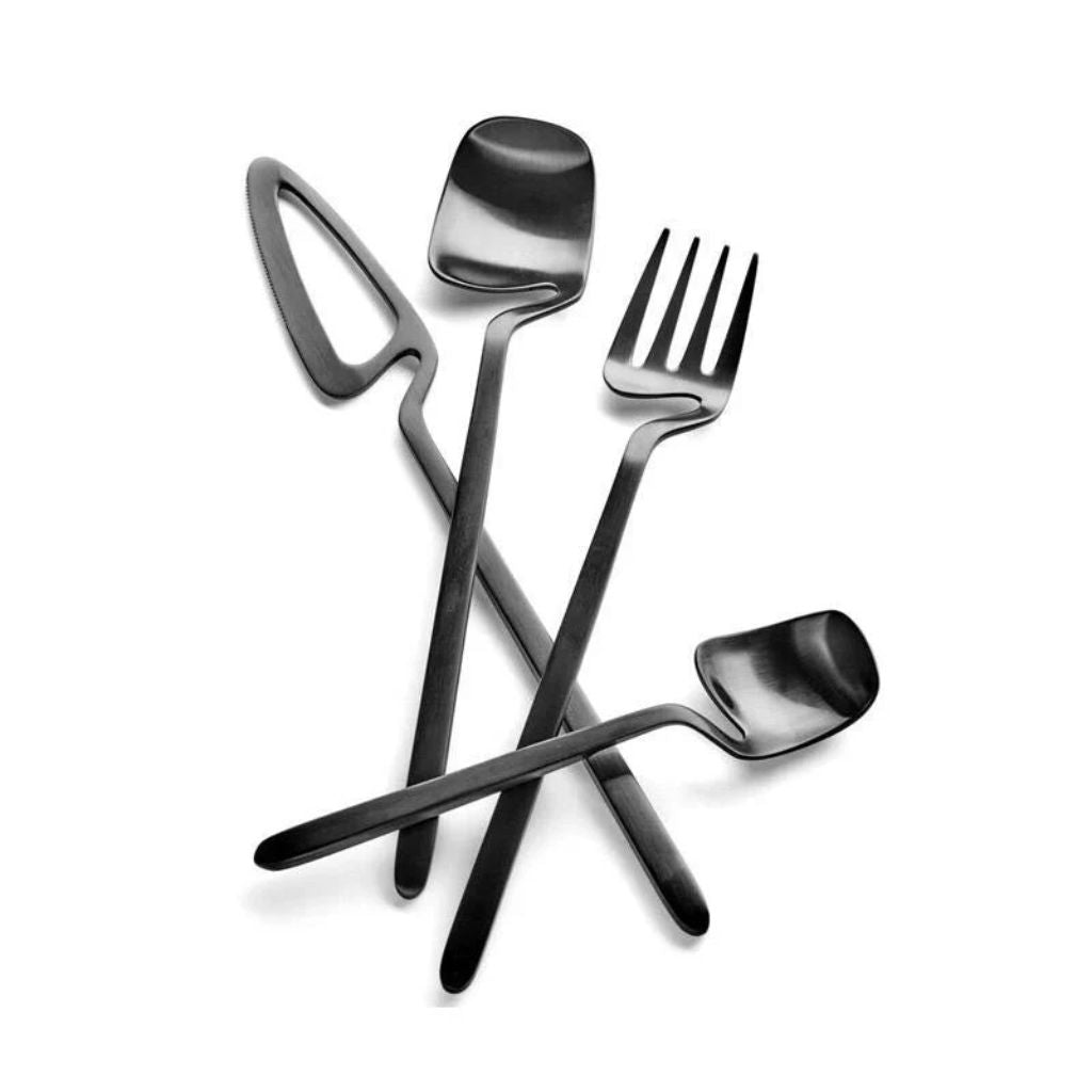 Black flatware knife, spoon, fork and teaspoon crossed over one another on white