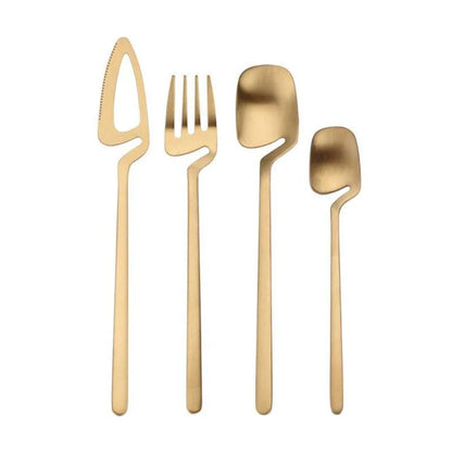 Gold flatware set: open-blade knife, fork, spoon and teaspoon standing upright on white