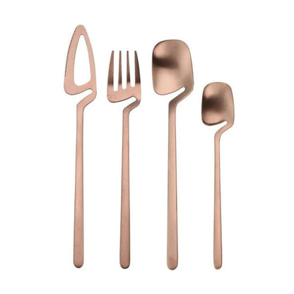 Rose gold flatware set: open-blade knife, fork, spoon and teaspoon standing upright on white