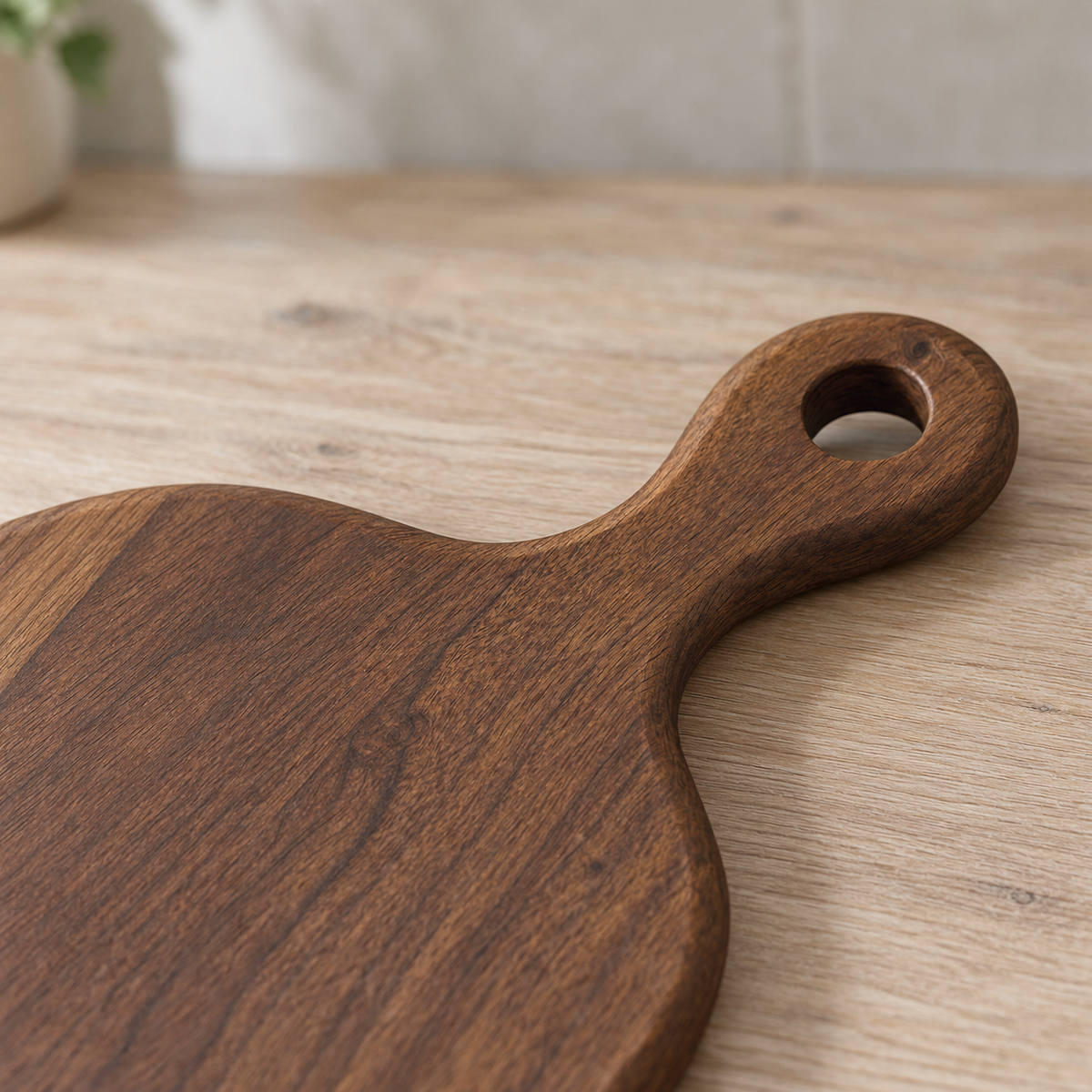 Close-up of the black walnut paddle handle with its hang hole and rounded edge