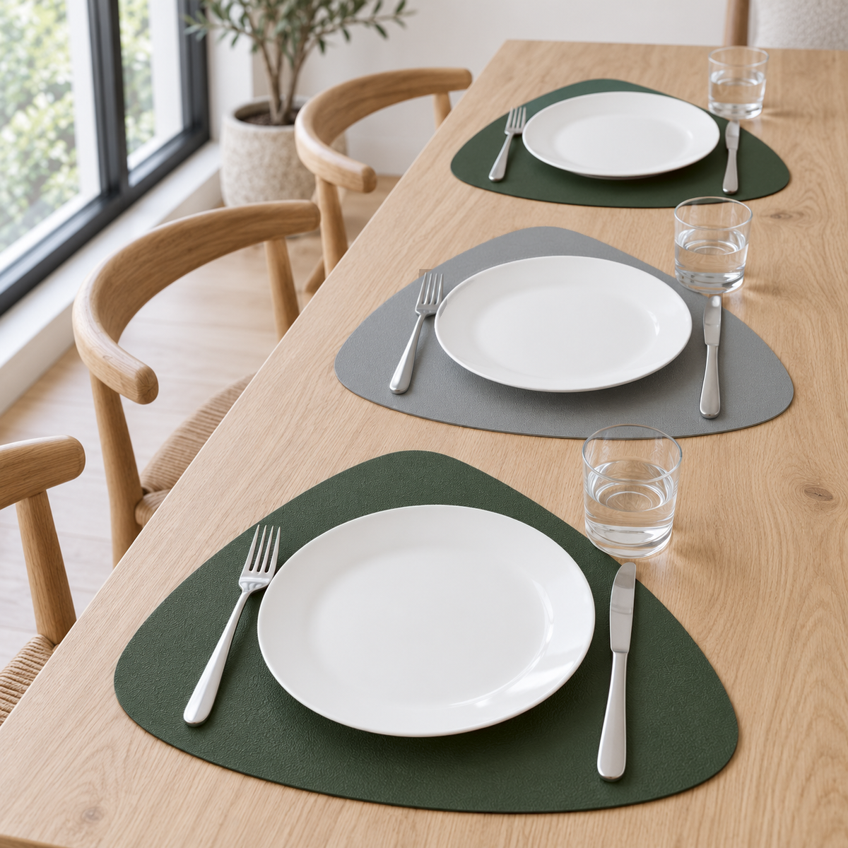 Gray and Green placemats on a long white oak table by a window, green and gray sides alternating