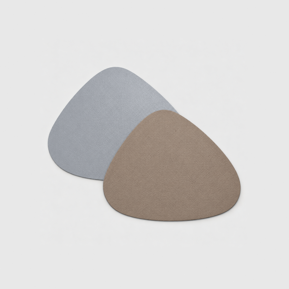 Two reversible placemats in Gray and Taupe, one showing the gray side and one the taupe side