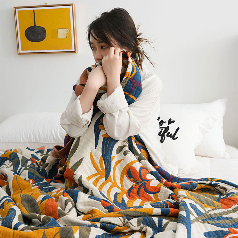 Cotton quilt wrapped around a woman's shoulders, the navy reverse showing at the top
