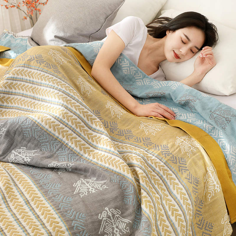 Woman asleep under the striped cotton quilt, its aqua reverse folded over her shoulder