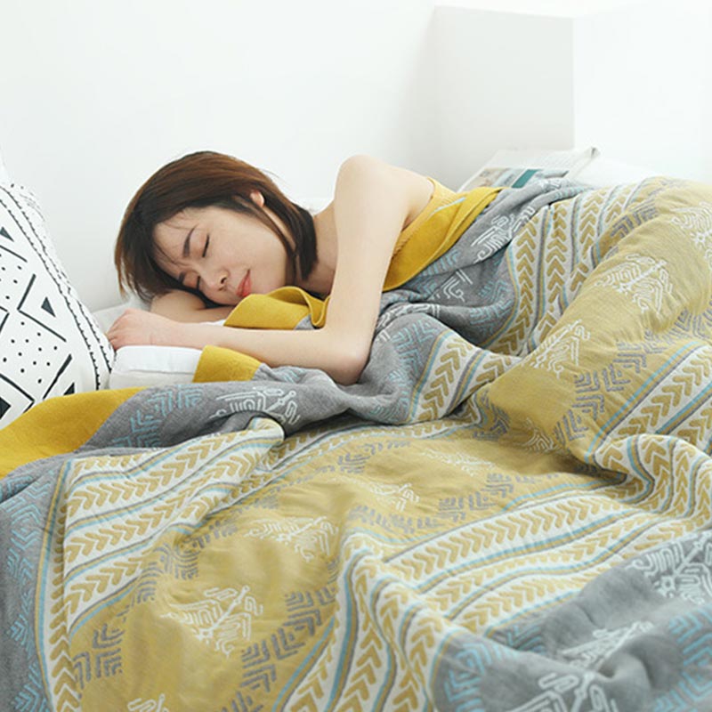 Soft cotton gauze quilt pulled up to the shoulders of a sleeping woman