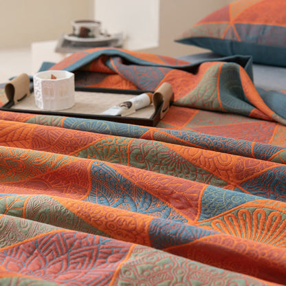 Close-up of the fine fan and medallion motifs inside each triangle of the cotton quilt