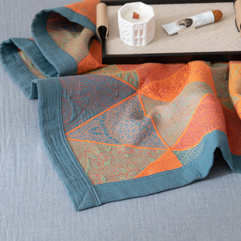 Corner of the quilt showing the crinkled slate blue border and the triangle pattern on both faces