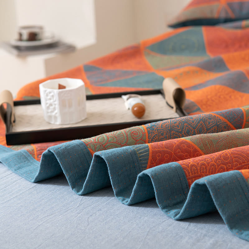 Folded edge of the quilt with its wide slate blue muslin border