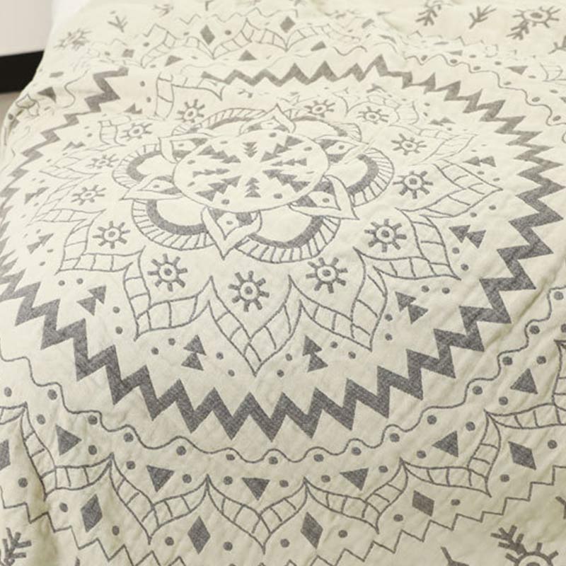 Close-up of the mandala rings on the cream face, a gray zigzag ring around pointed petals and diamonds