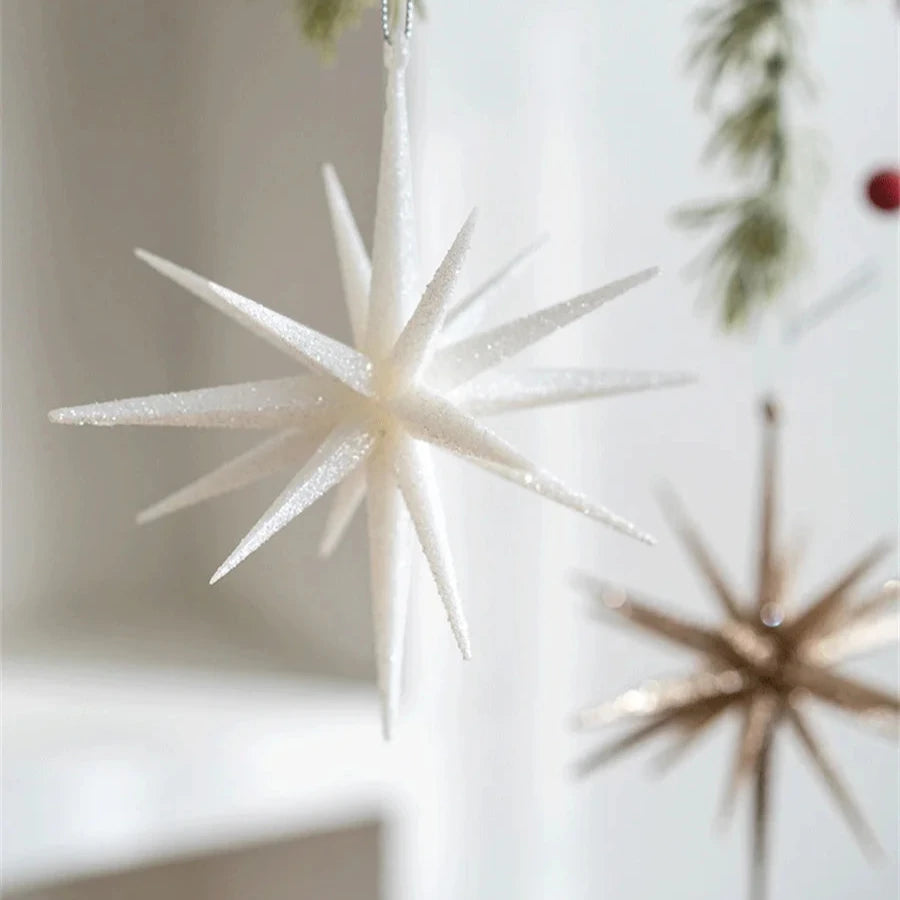 Large white glitter star ornament with a champagne starburst hanging behind it