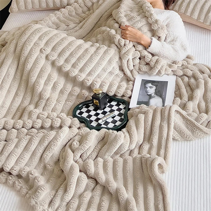 Beige faux fur throw pulled over a bed, its pleats curling into plump rolls at the edge