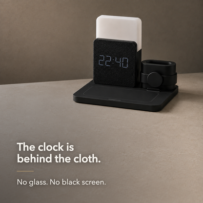 The clock is behind the cloth - LED digits shining through the woven fabric face, no glass and no black screen